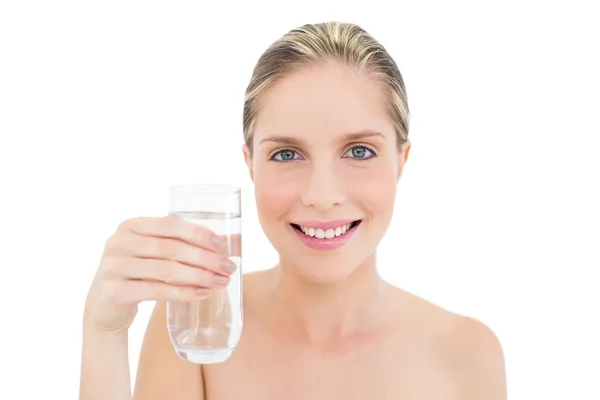 Amused fresh blonde woman holding a glass of water — Stock Photo, Image