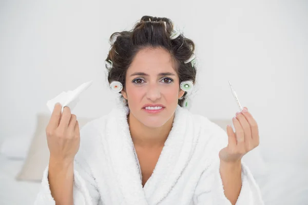 Desperate natural brunette holding thermometer and tissue — Stock Photo, Image