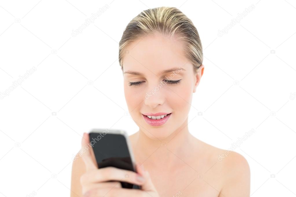 Focused fresh blonde woman using her mobile phone