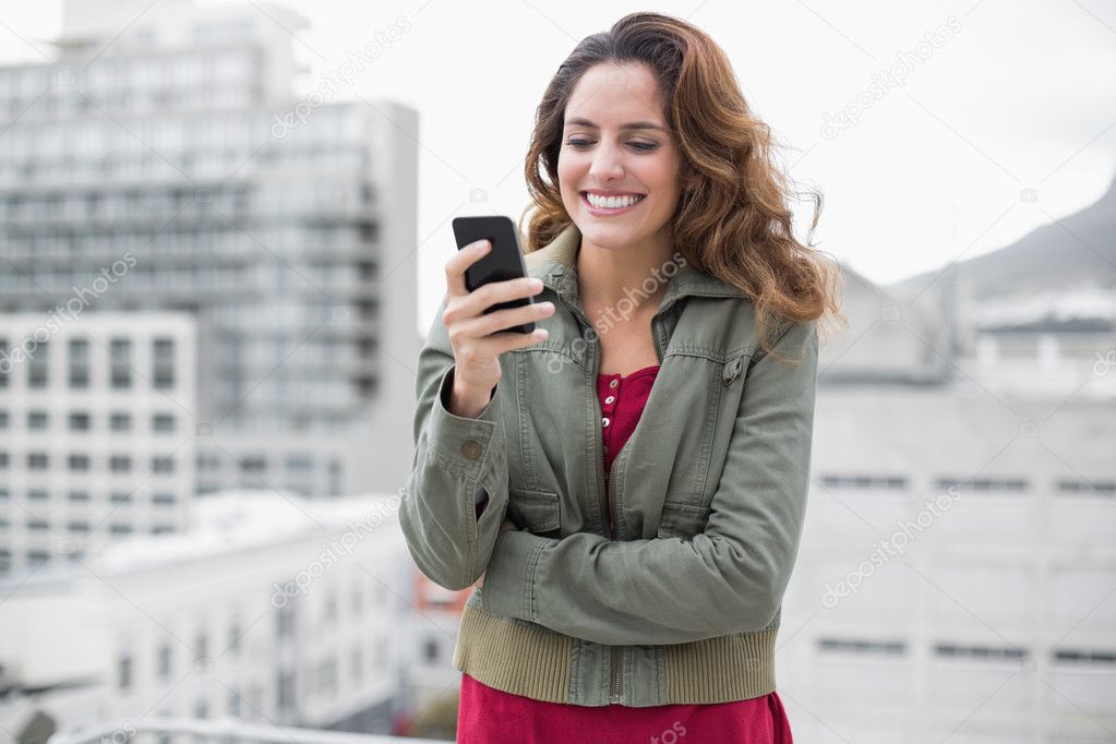 Brunette in winter fashion holding smartphone