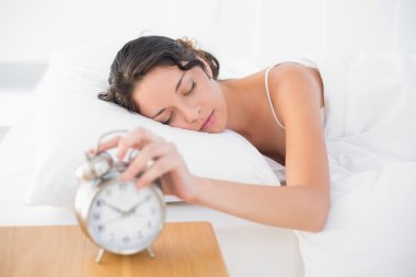 uykulu casual esmer beyaz pijamalı alarm saatini Torna