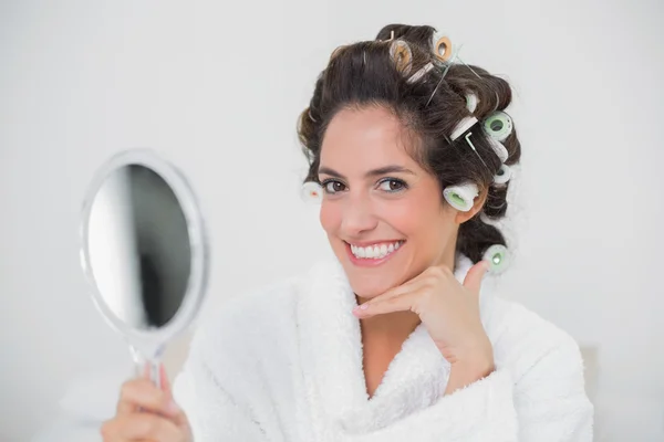 Happy natural brunette holding hand mirror — Stock Photo, Image