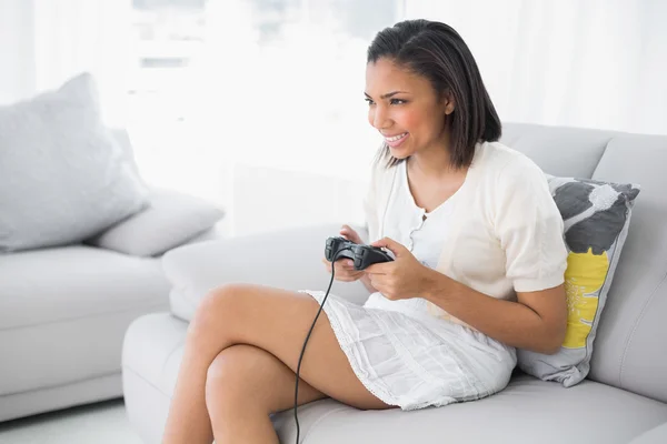 Delighted young woman playing video games — Stock Photo, Image