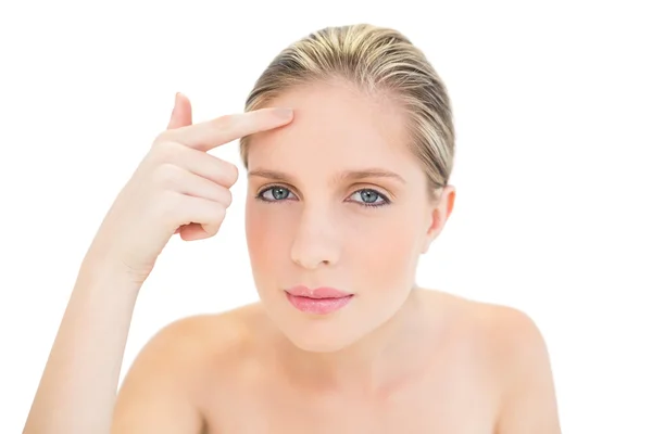 Thoughtful fresh blonde woman pointing her brow with her finger — Stock Photo, Image