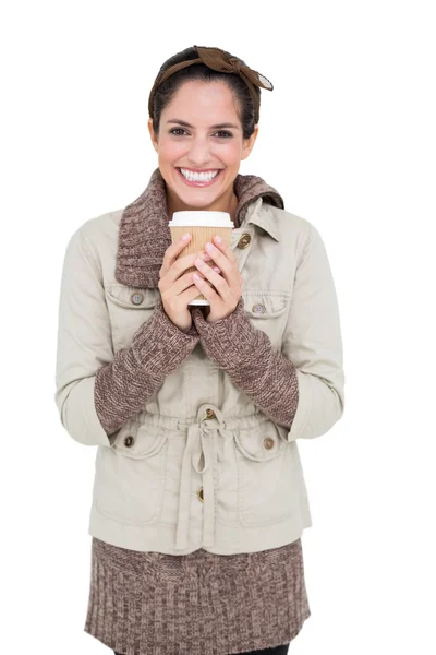 Cheerful cute brunette in winter fashion holding disposable cup — Stock Photo, Image