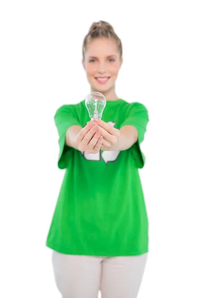 Cheerful activist wearing recycling tshirt holding light bulb — Stock Photo, Image