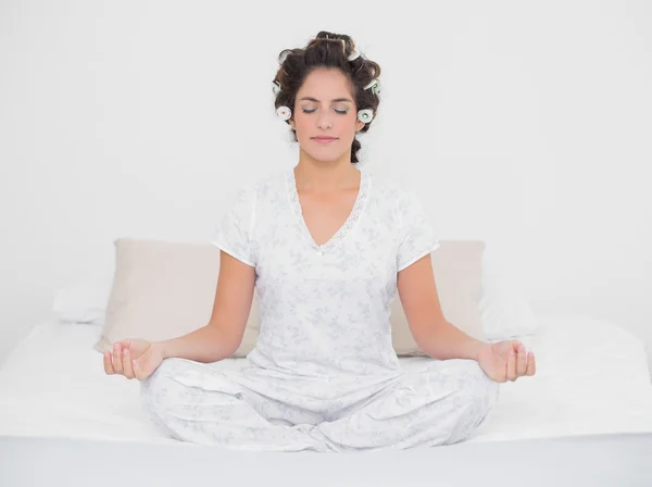 Peaceful natural brunette sitting in lotus pose — Stock Photo, Image