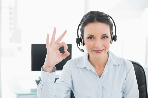 Joyful stylish brunette operator making an okay gesture — Stock Photo, Image