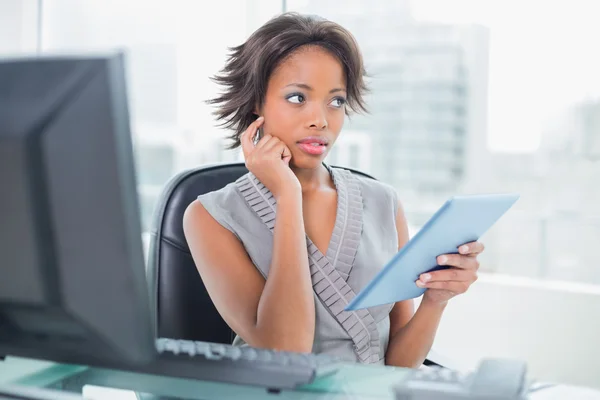 Thoughtful businesswoman using tablet — Stock Photo, Image