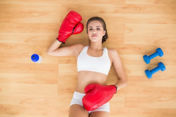 Sporty woman wearing red boxing gloves — Stock Photo, Image