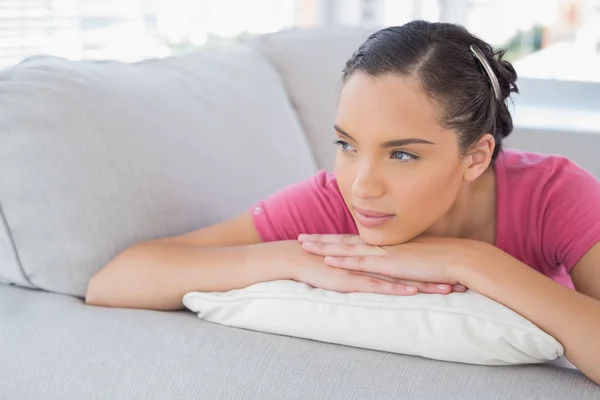 Side view of thoughtful woman lying on the sofa — Stock Photo, Image