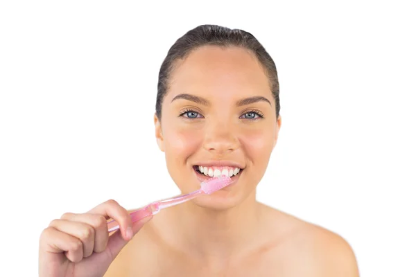 Smiling woman brushing her teeth — Stock Photo, Image