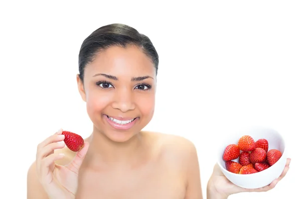 Content young model eating strawberries — Stock Photo, Image