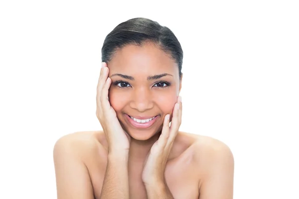 Delighted young dark haired model touching her face — Stock Photo, Image