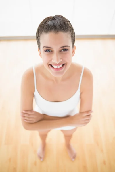 Woman in white sportswear posing with arms folded — Stock Photo, Image