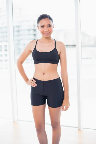 Conten model in sportswear posing with a hand on the hip — Stock Photo, Image