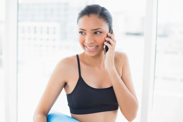 Pensive model in sportswear making a phone call — Stock Photo, Image