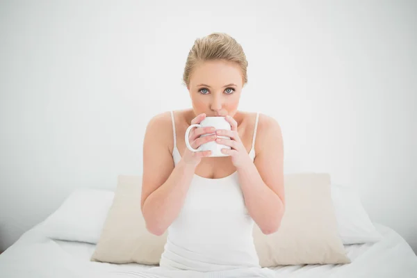 Φυσικά ελκυστική ξανθιά που πίνει νερό από μια κούπα — Φωτογραφία Αρχείου