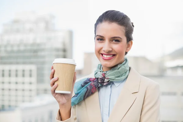 Pleased businesswoman holding a cup of coffee — Stock Photo, Image