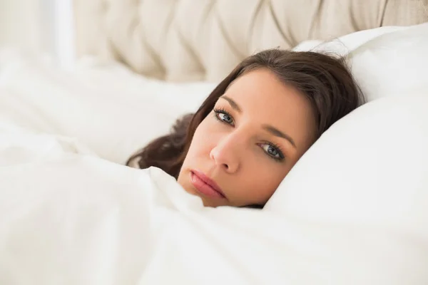 Relaxed pretty woman lying in her bed — Stock Photo, Image