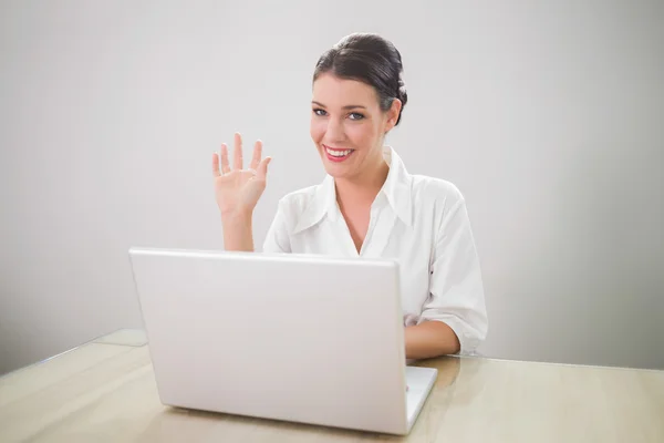 Winkende Geschäftsfrau mit Laptop — Stockfoto