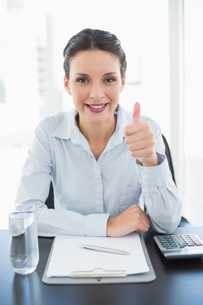 Pleased stylish brunette businesswoman giving thumb up — Stock Photo, Image