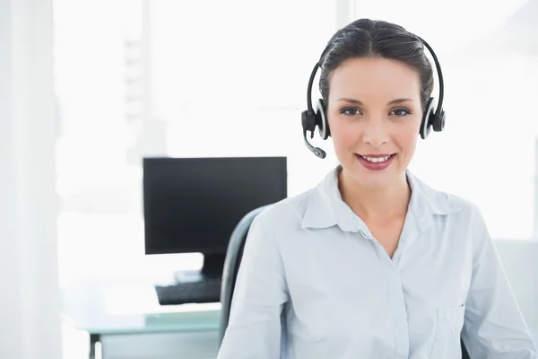 Pleased stylish brunette operator posing looking at camera — Stock Photo, Image