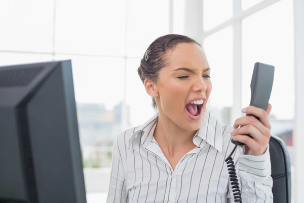 Angry businesswoman screaming at phone — Stock Photo, Image