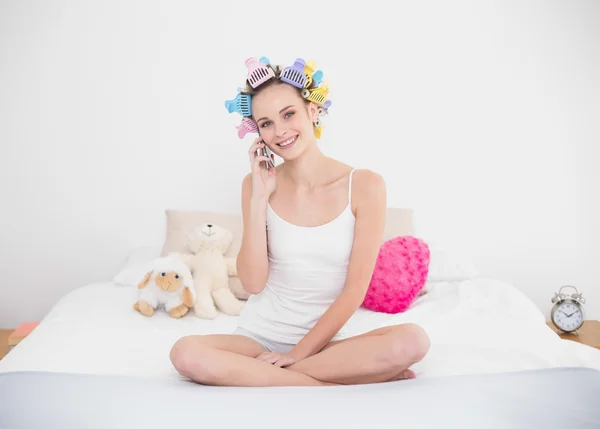 Delighted woman in hair curlers making a phone call — Stock Photo, Image