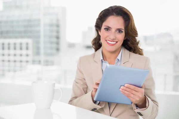Beautiful cheerful businesswoman using tablet — Stock Photo, Image