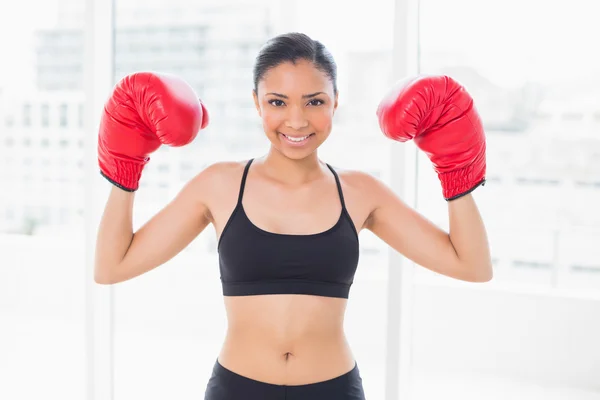Lovely model in sportswear wearing red boxing gloves — Stock Photo, Image