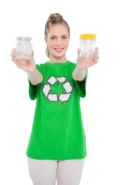 Cheerful environmental activist wearing recycling tshirt holding jars — Stock Photo, Image