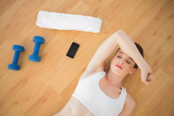 Exhausted fit model in sportswear relaxing after sport — Stock Photo, Image
