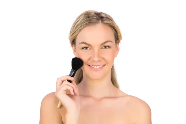 Smiling pretty bare blonde using powder brush — Stock Photo, Image