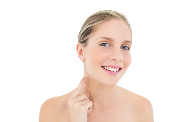 Pleased fresh blonde woman pointing her neck with her finger — Stock Photo, Image