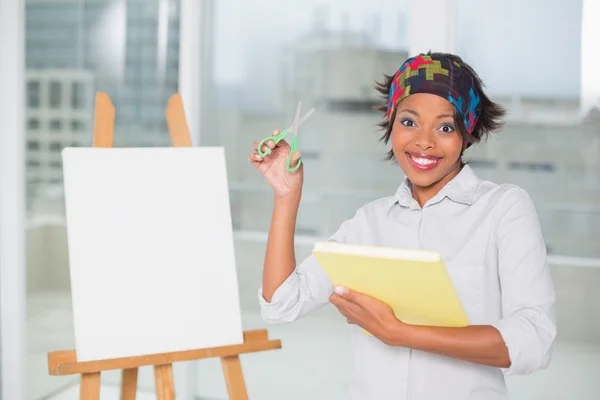 Funny artistic woman holding scissors and sketchpad — Stock Photo, Image