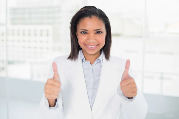 Pleased young businesswoman giving thumbs up — Stock Photo, Image