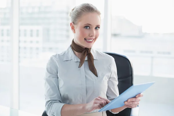 Blonde cheerful businesswoman using tablet — Stock Photo, Image