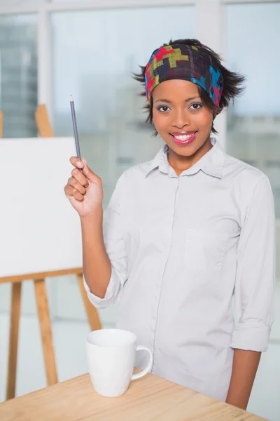 Smiling artist holding a pen — Stock Photo, Image