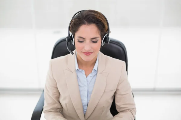 Happy call center agent sitting in swivel chair — Stock Photo, Image