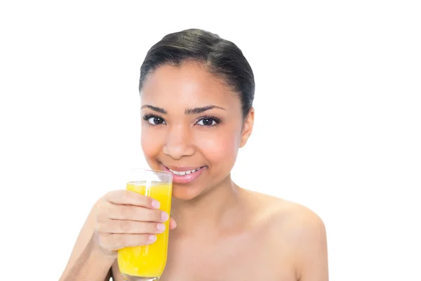 Happy young model drinking orange juice — Stock Photo, Image