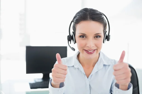 Cheerful stylish brunette operator giving thumbs up — Stock Photo, Image