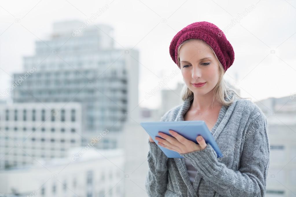 Peaceful pretty blonde using tablet pc outdoors