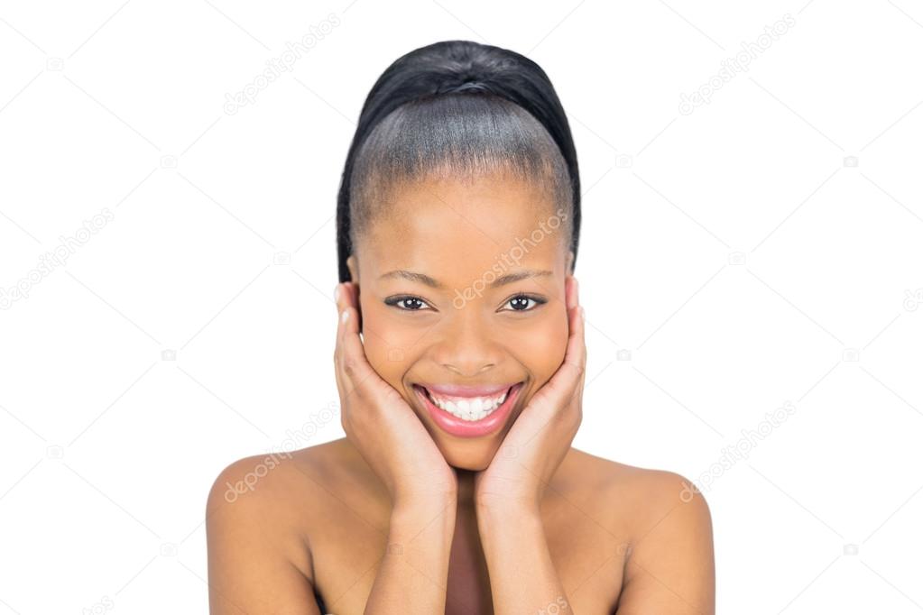 Smiling woman holding her face and looking at camera