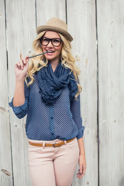 Happy trendy blonde biting pencil — Stock Photo, Image