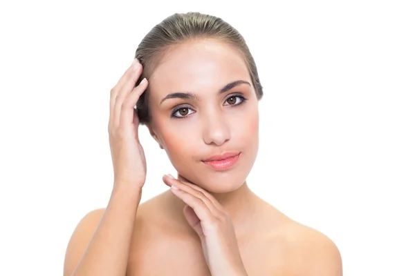 Calm young woman touching her head — Stock Photo, Image