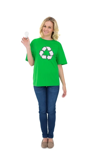 Smiling cute environmental activist holding light bulb — Stock Photo, Image