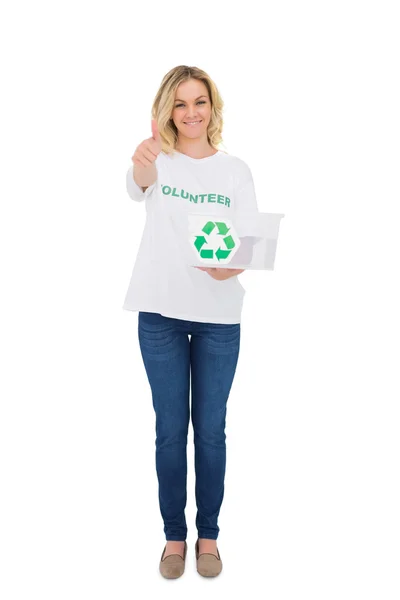 Smiling blonde volunteer holding recycling box giving thumb up to camera — Stock Photo, Image