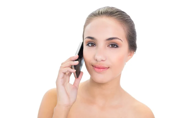 Smiling young woman holding a mobile phone — Stock Photo, Image