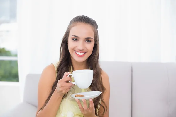 Smiling pretty brunette holding a cup — Stock Photo, Image